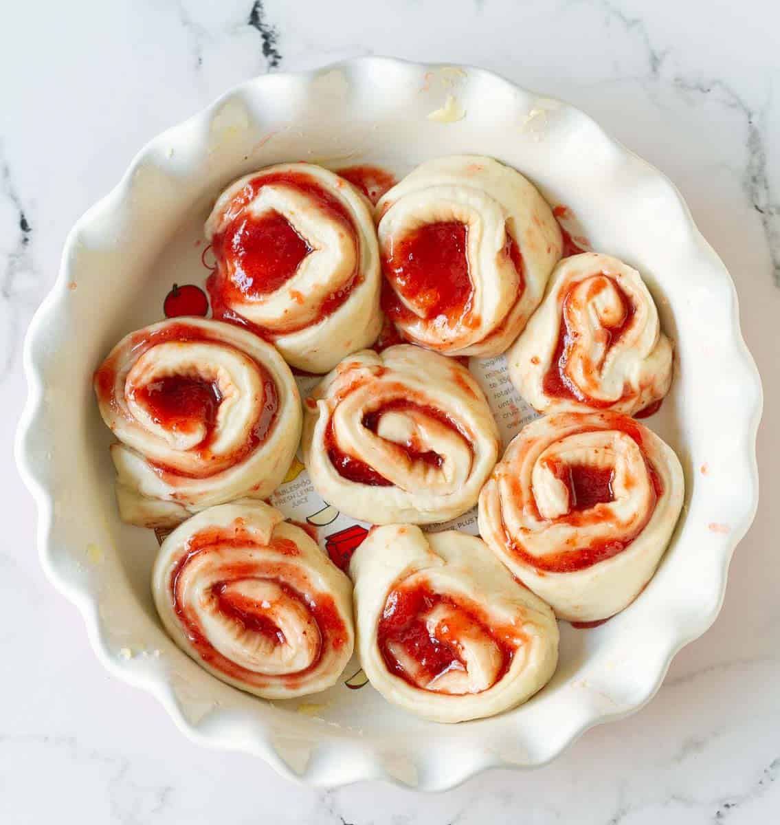 sliced dough roll in a baking pan