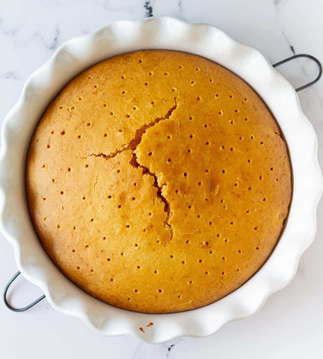 Poke holes with a skewer all over the cake for tres leches cake.