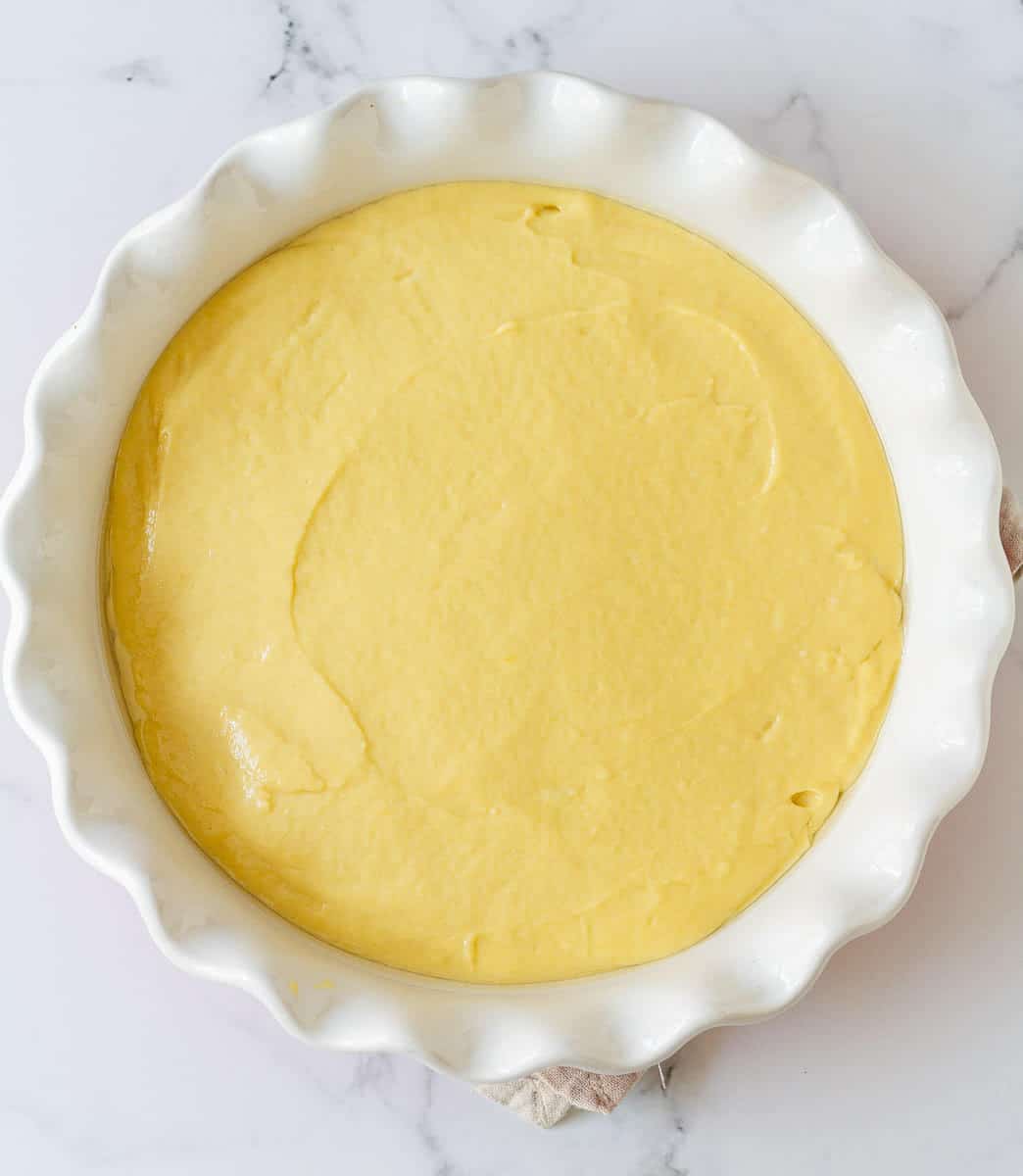 cake batter in a round baking dish.