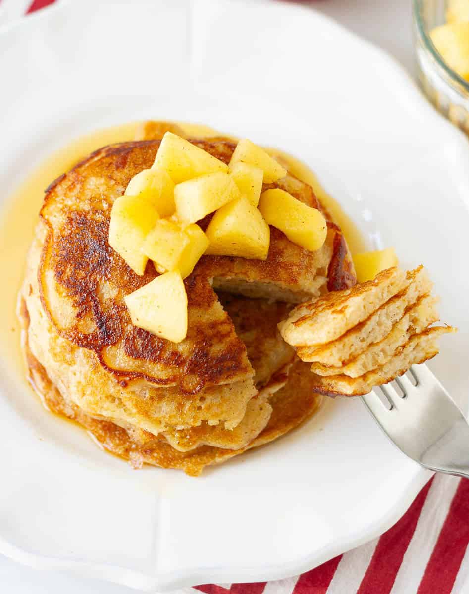 A bite of pancakes on a fork.
