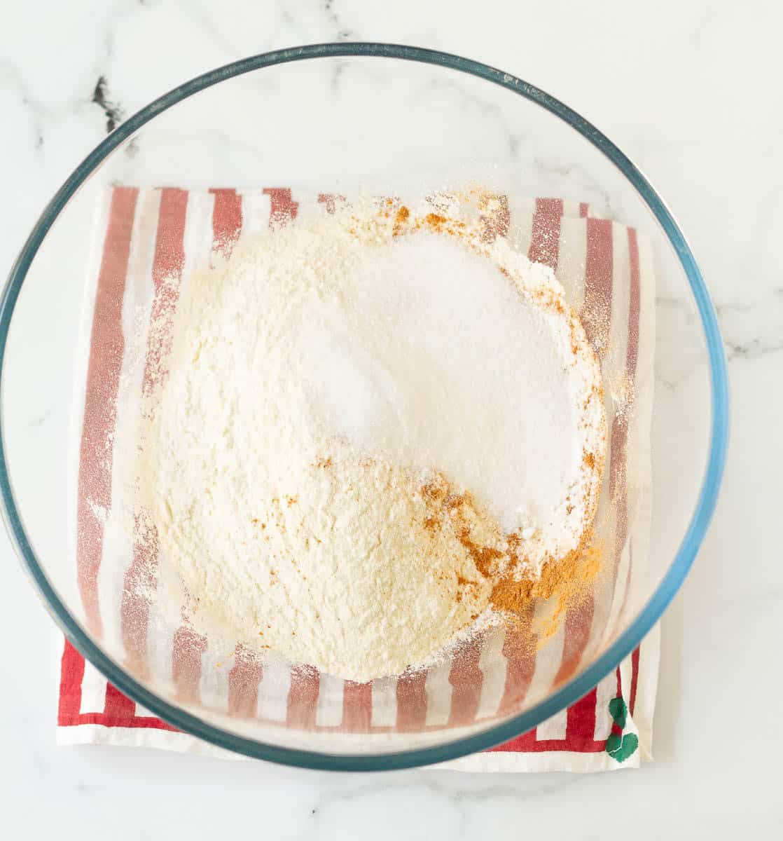 dry ingredients for making apple pancakes in a glass bowl.