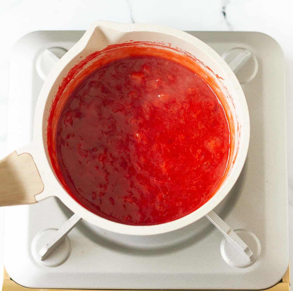strawberry filling in a white saucepan.