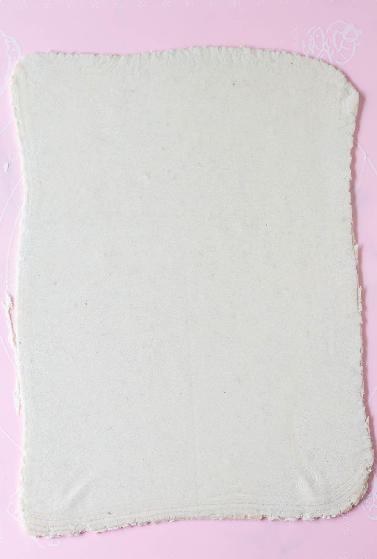 rolled out puff pastry on a silicone mat.
