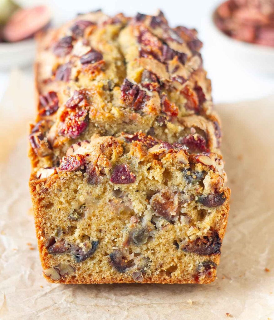 Sliced fig bread on parchment paper to show the cross section.