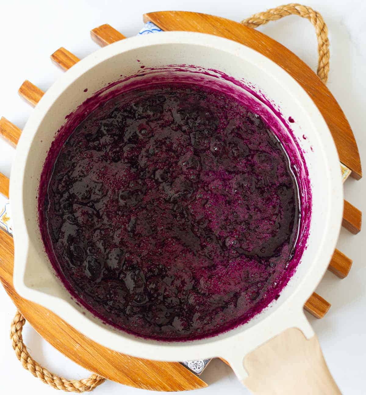 Cooked blueberry syrup in a saucepan.