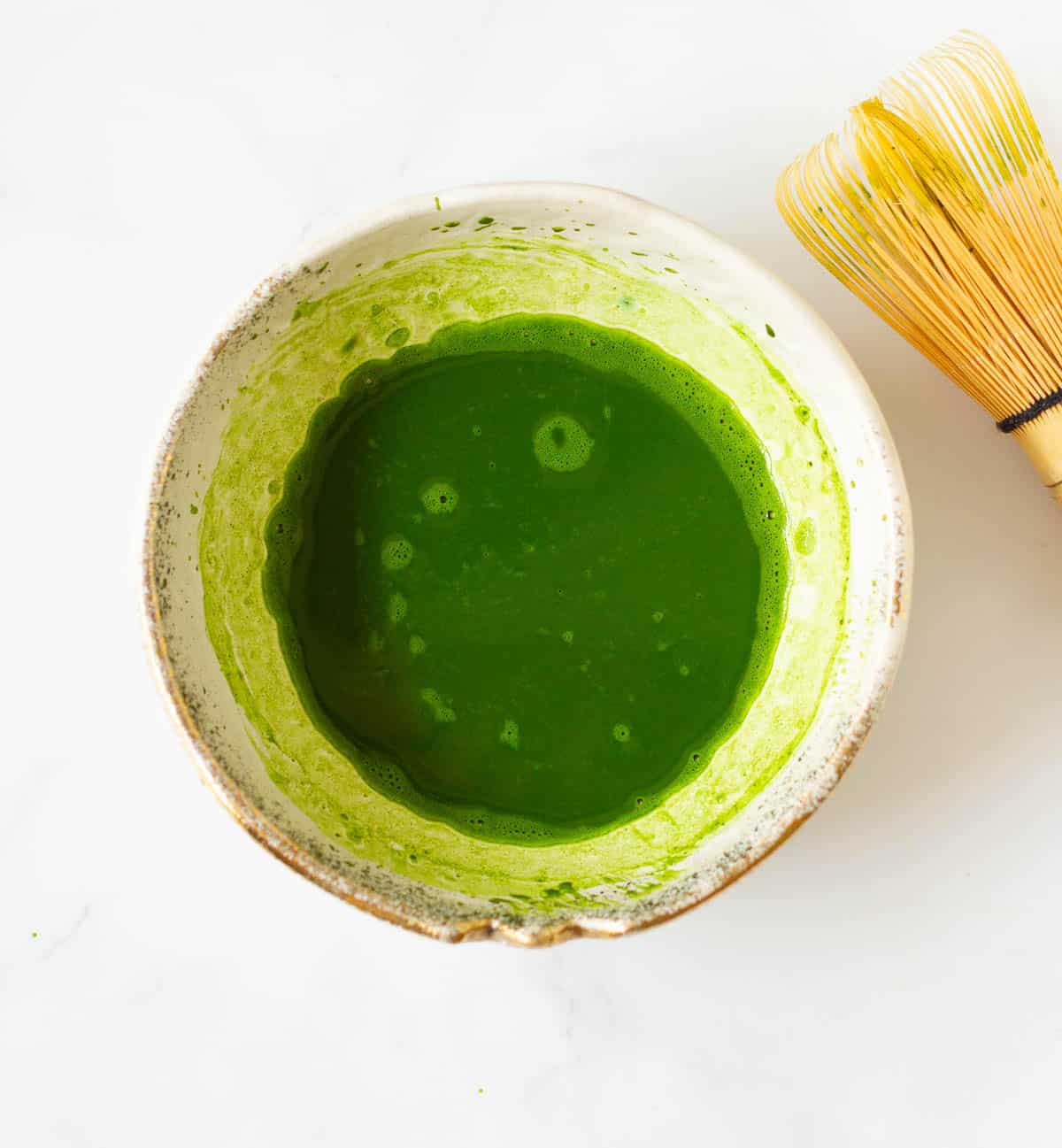 Matcha whisked with water in a bowl.