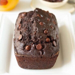 Chocolate zucchini bread on a white platter.