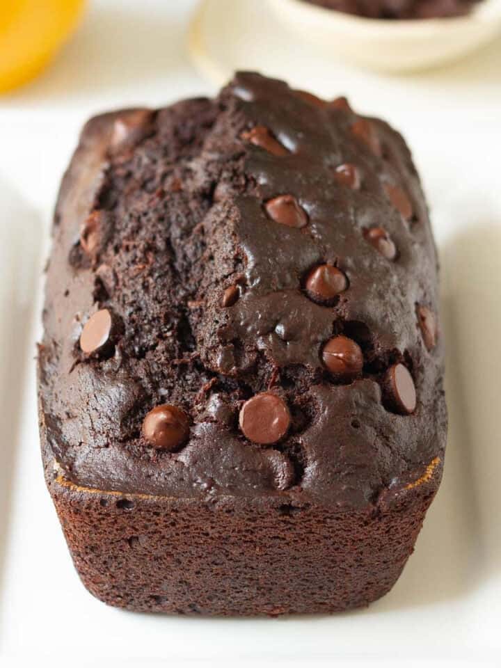 Chocolate zucchini bread on a white platter.