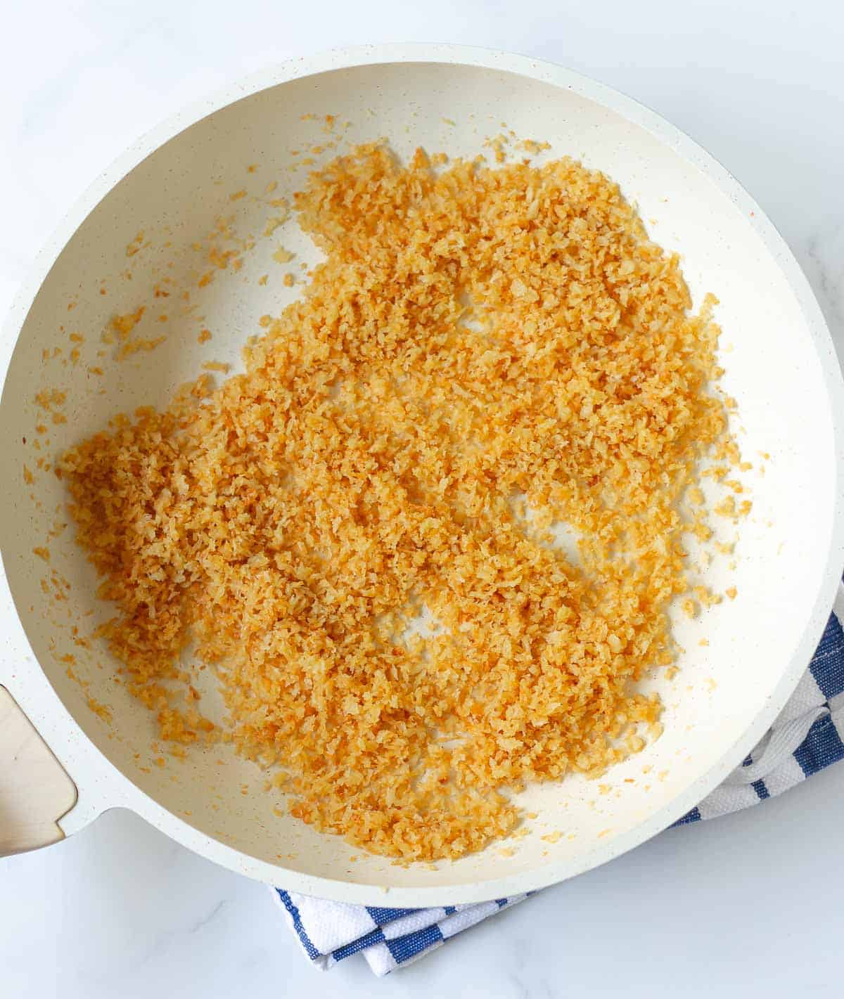 Toasted panko breadcrumbs in a saucepan.