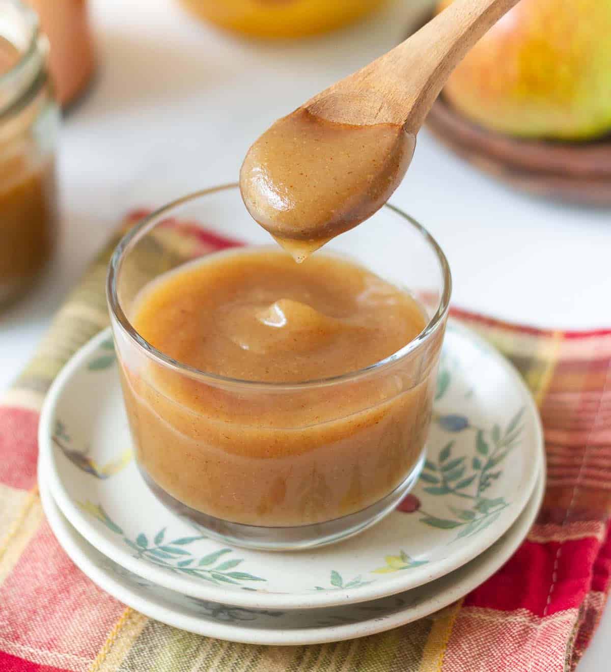 A spoonful of pear butter out of a jar,