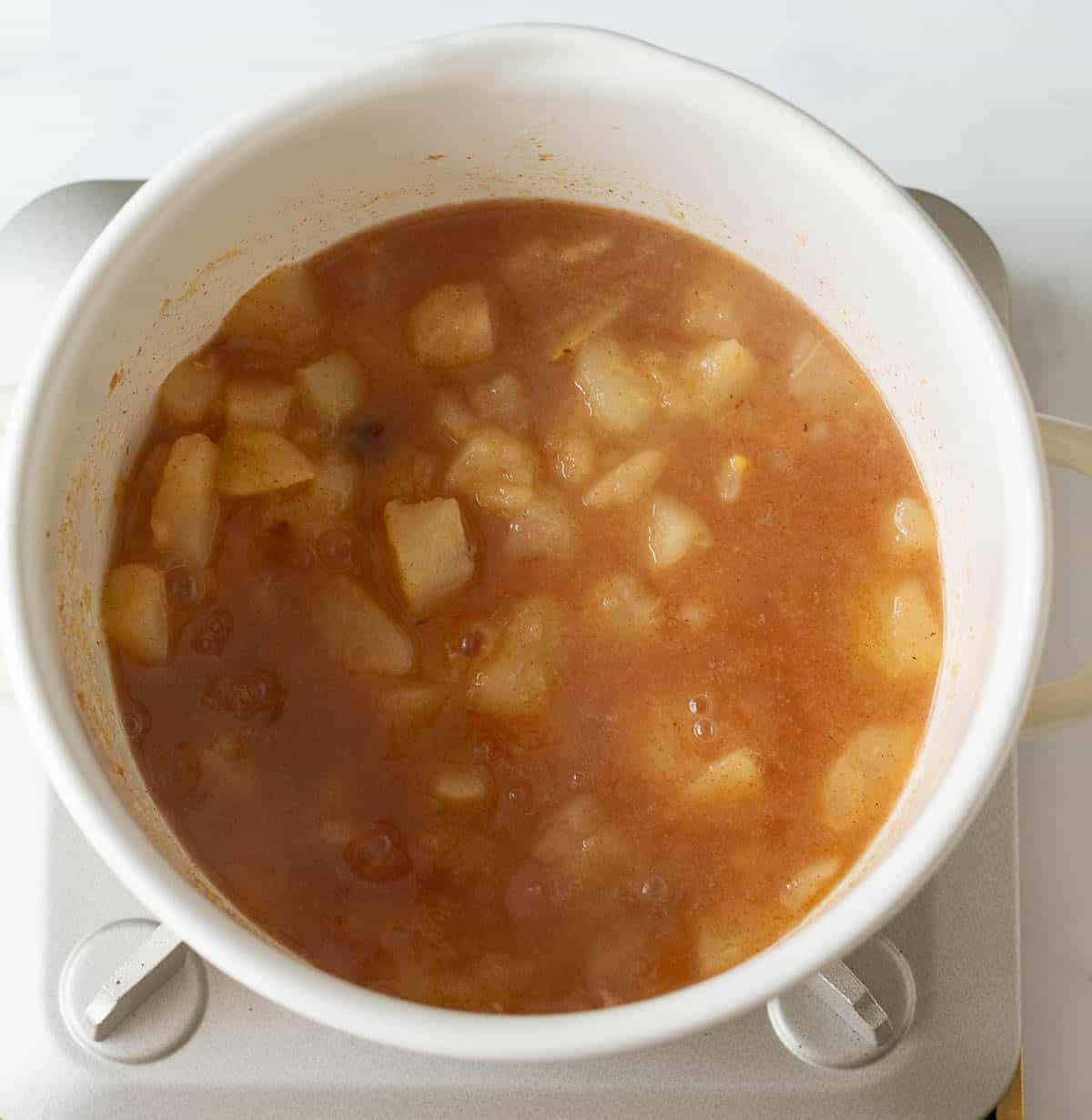 Cooked down pears in a stock pot.