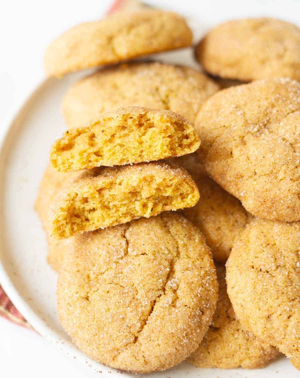 Cookies on a plate with 2 halves of a cookie.