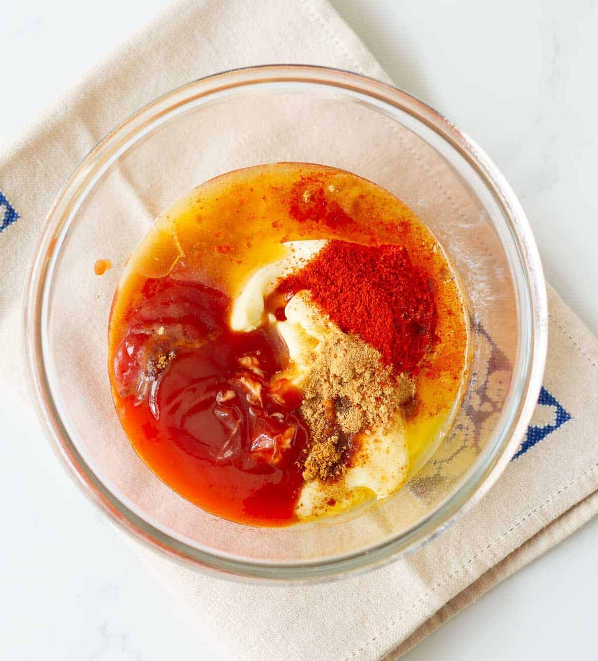Mayonnaise, ketchup, butter, paprika, garlic and onion powder in a mixing bowl.
