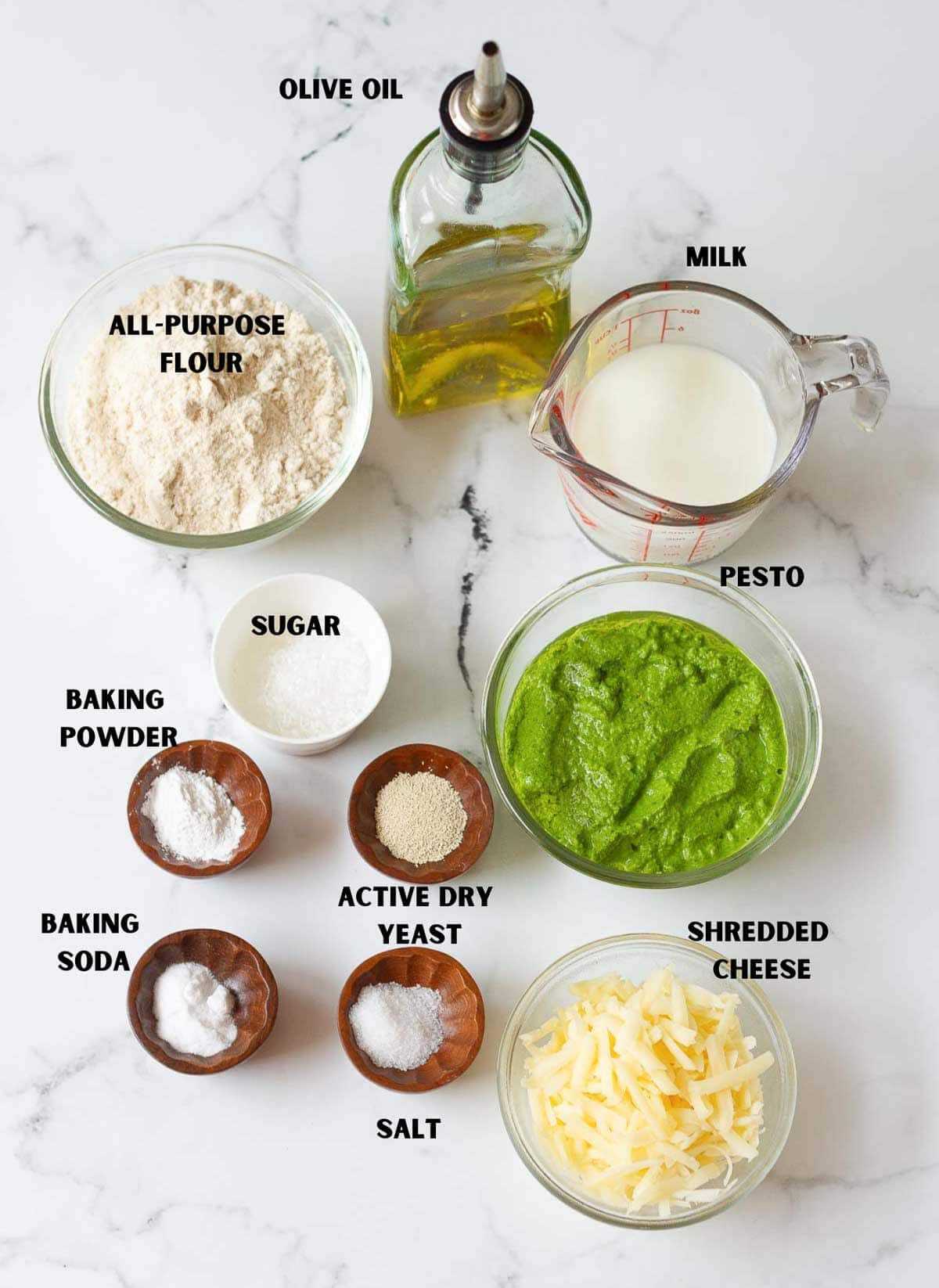 labelled ingredients for making cheesy pesto rolls.