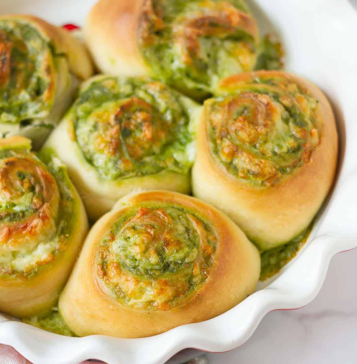 Pesto rolls in a baking dish.