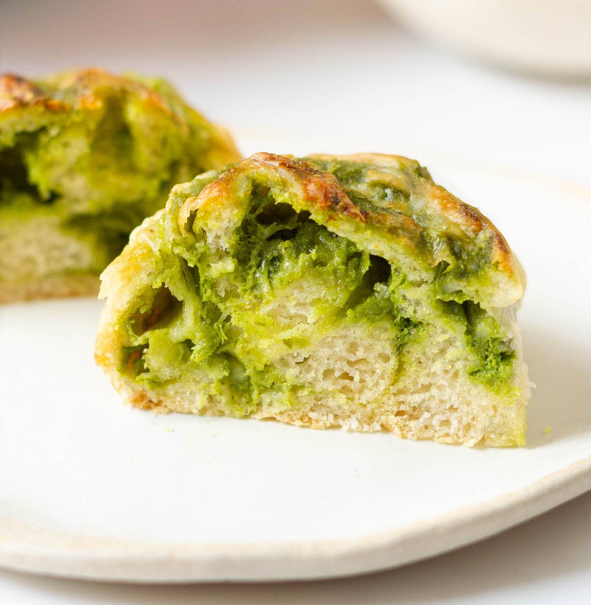 A pesto roll cut into half to show the cross section.