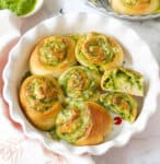 Pesto rolls in a pan and one cut in half.