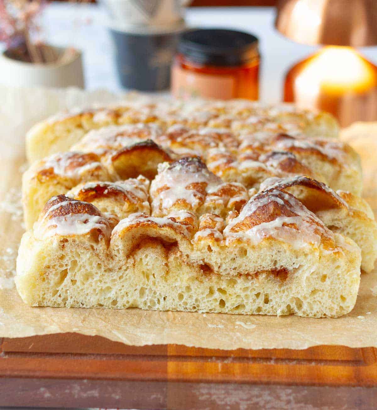 Sliced focaccia with cinnamon swirl on parchment paper.