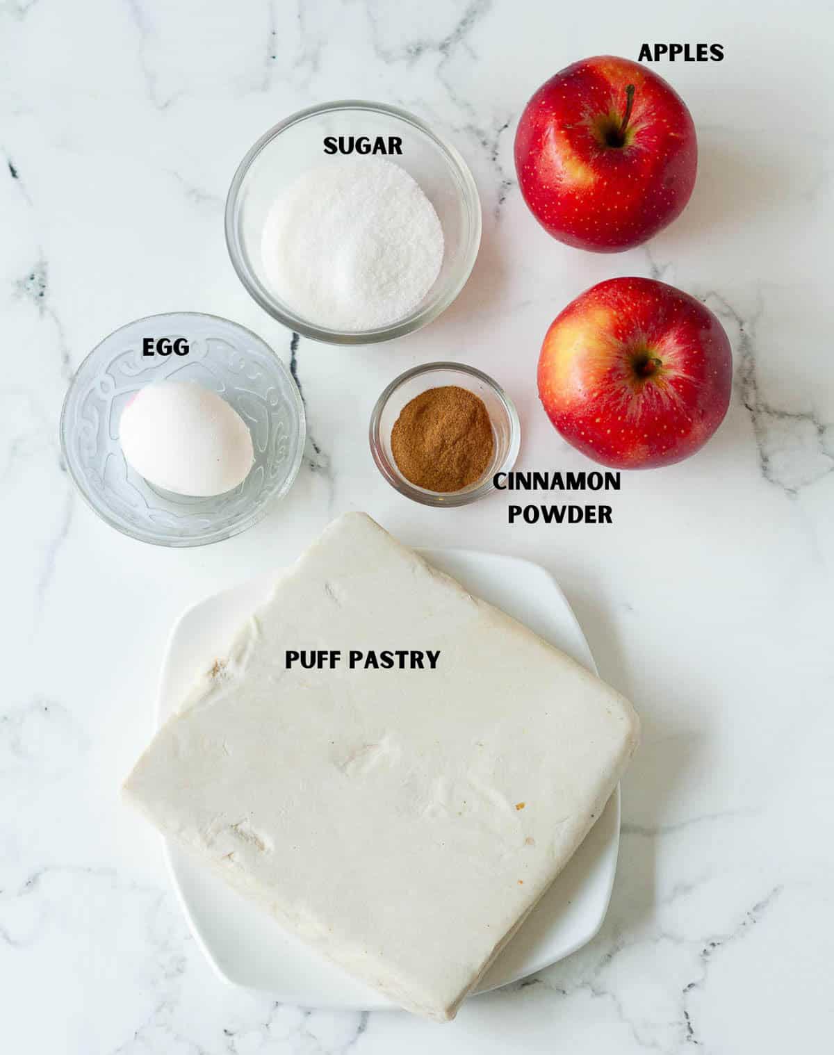 Labelled ingredients for making puff pastry apple donuts.