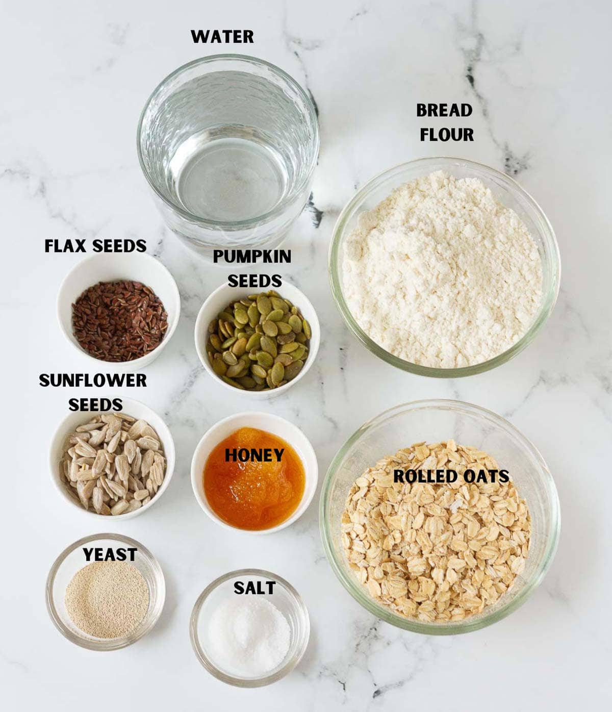 labelled ingredients for making no knead seeded oatmeal bread.