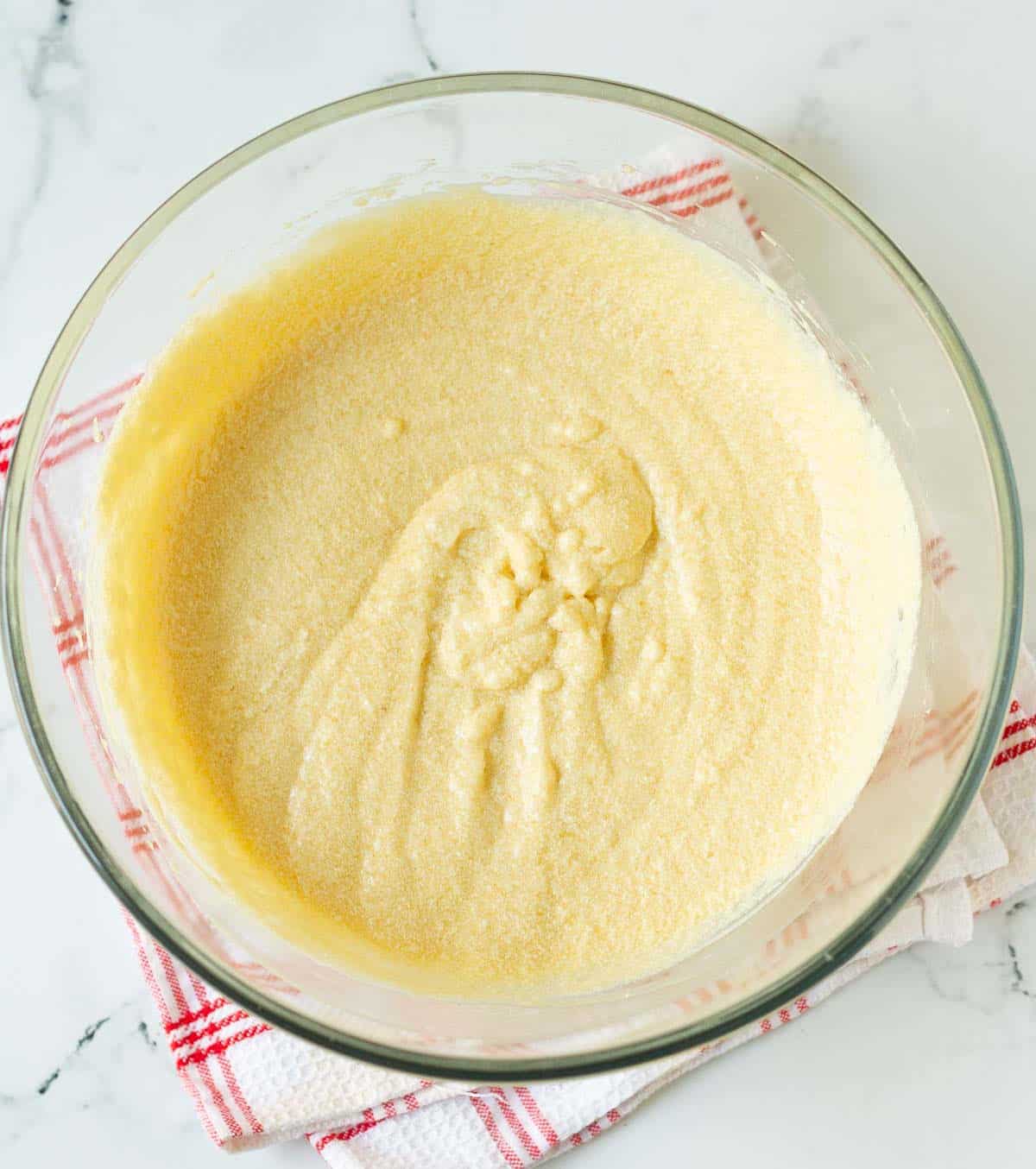 Wet ingredients for making cake in a mixing bowl.