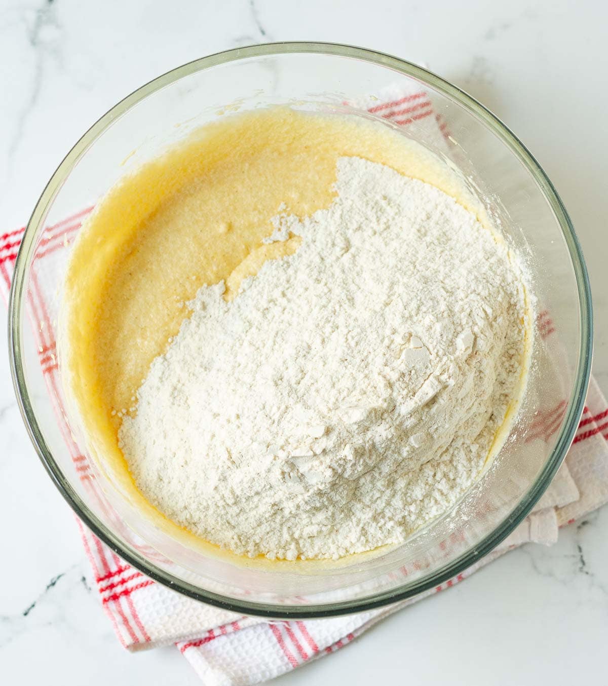 Dry ingredients on top of wet ingredients in a mixing bowl.
