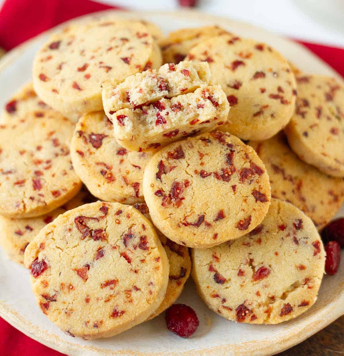 A plateful of cookies with one cookie cut in half to show the cross-section.