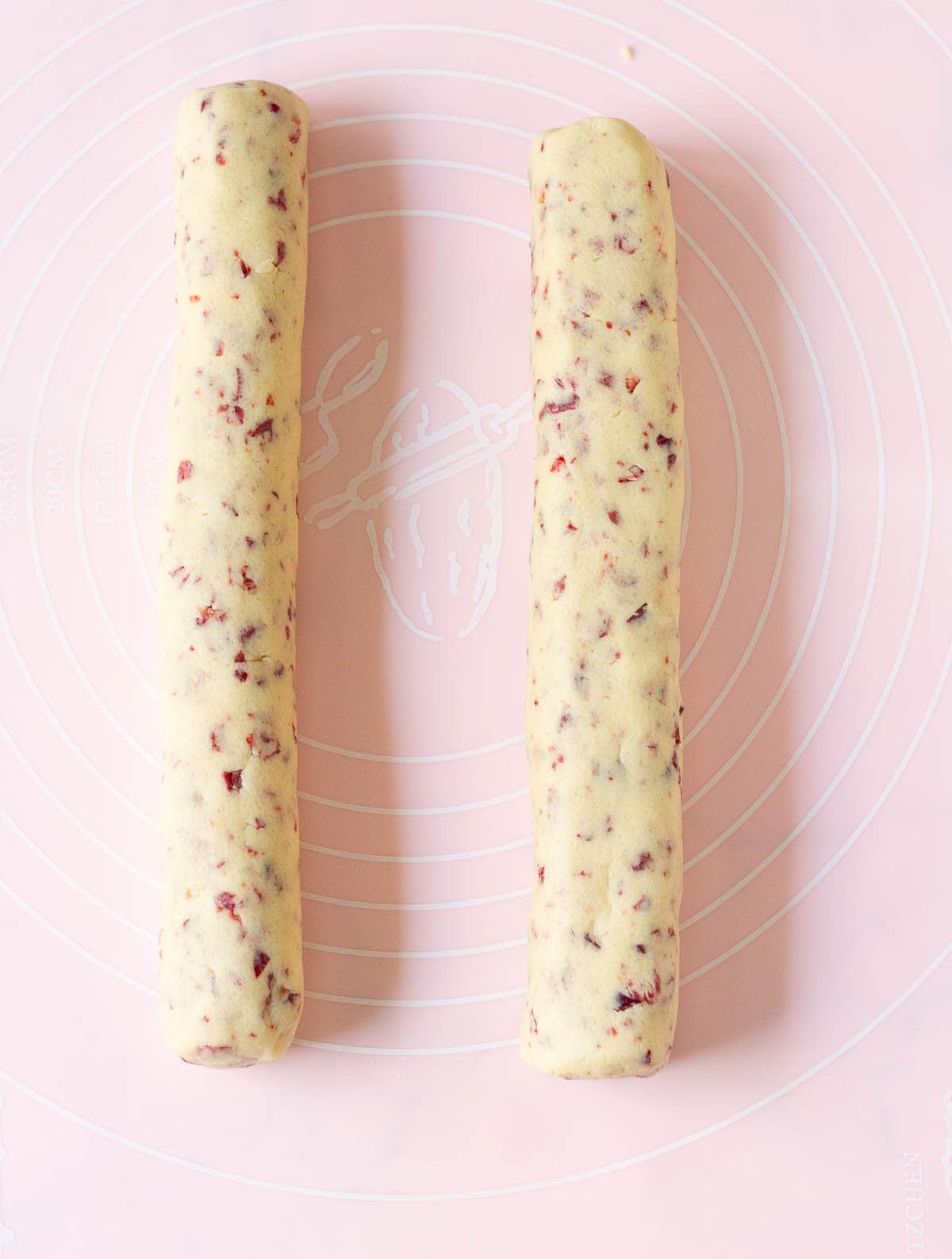 2 Cookie dough logs on a silicone mat.
