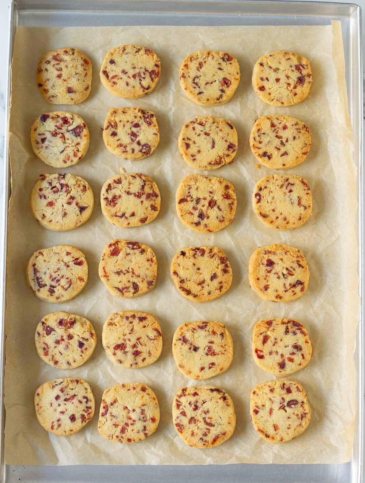 Baked cookies on a parchment-lined tray.