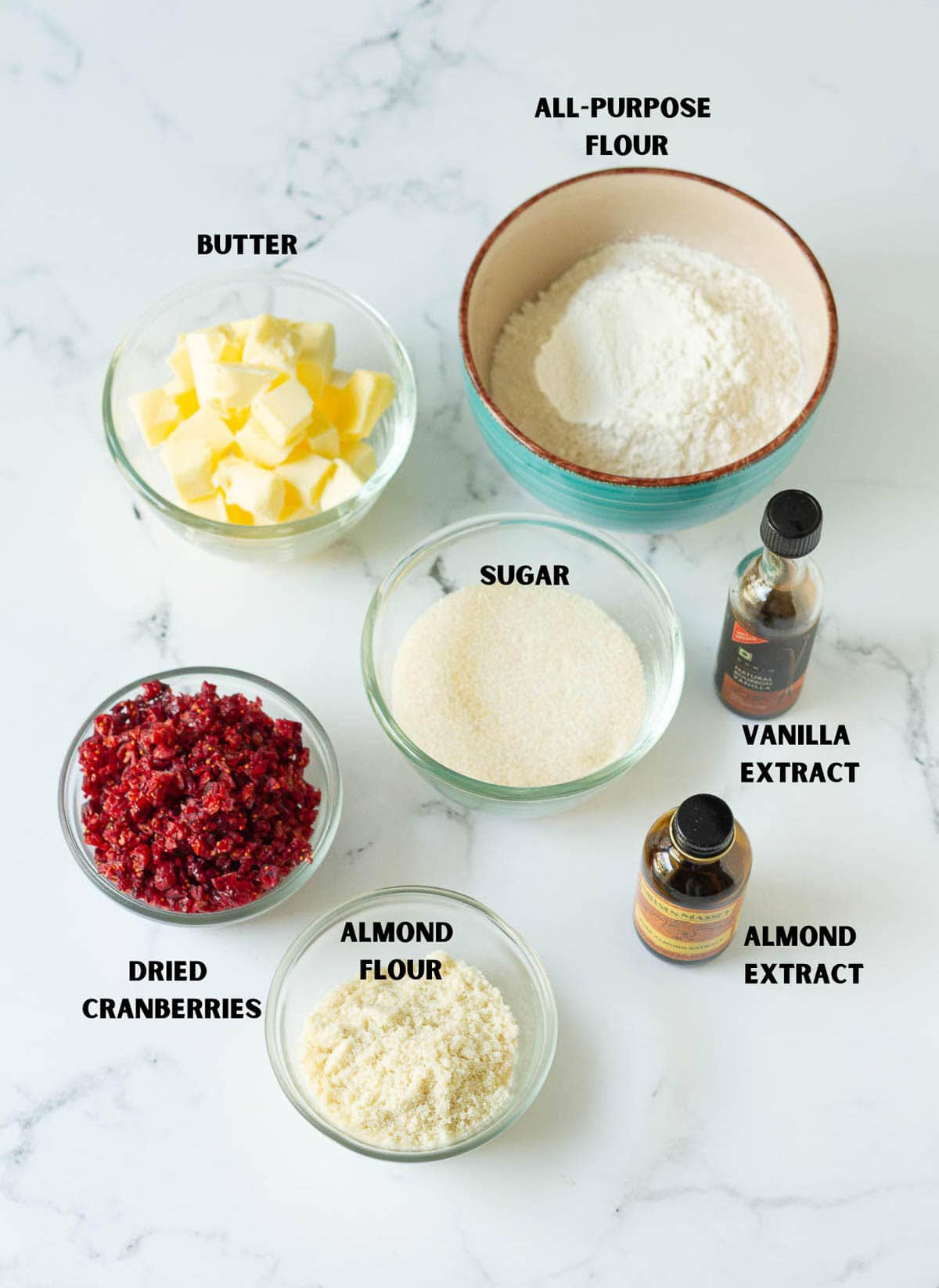Labelled ingredients for making cranberry almond shortbread cookies.