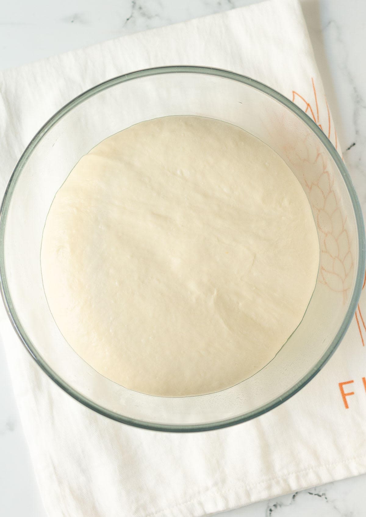 Proofed dough in a mixing bowl.
