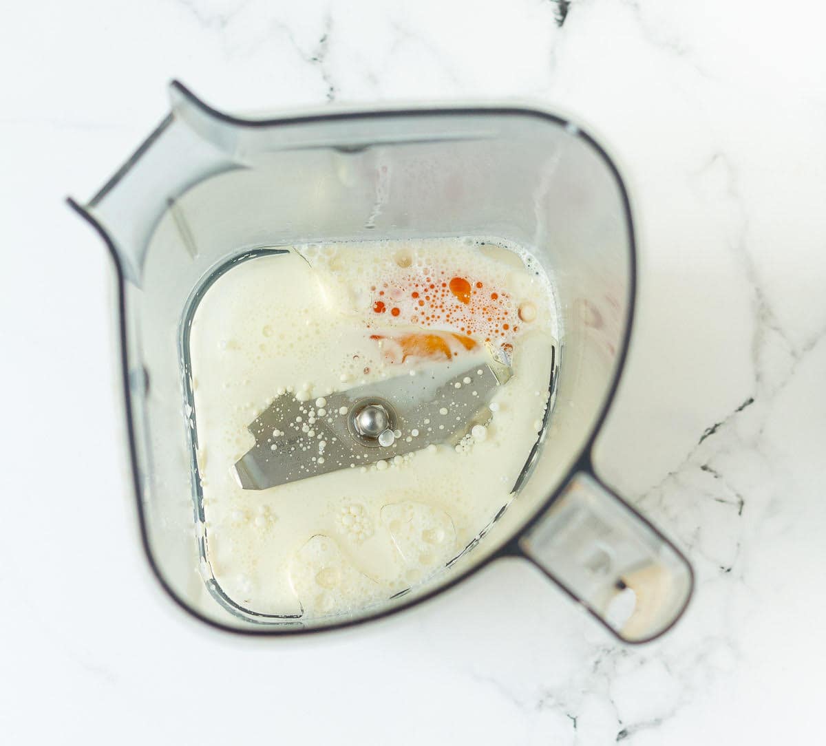 Milk, oil, egg in a blender jar.