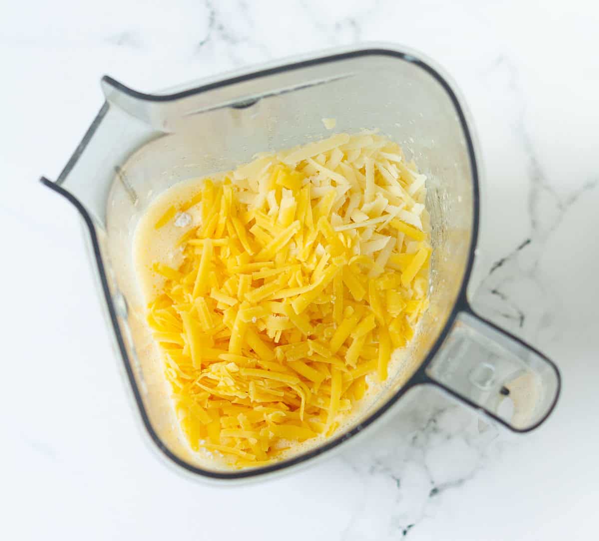 Shredded cheese in a blender jar.