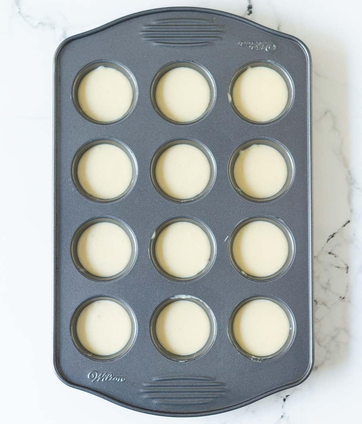 Batter in a mini muffin tray.