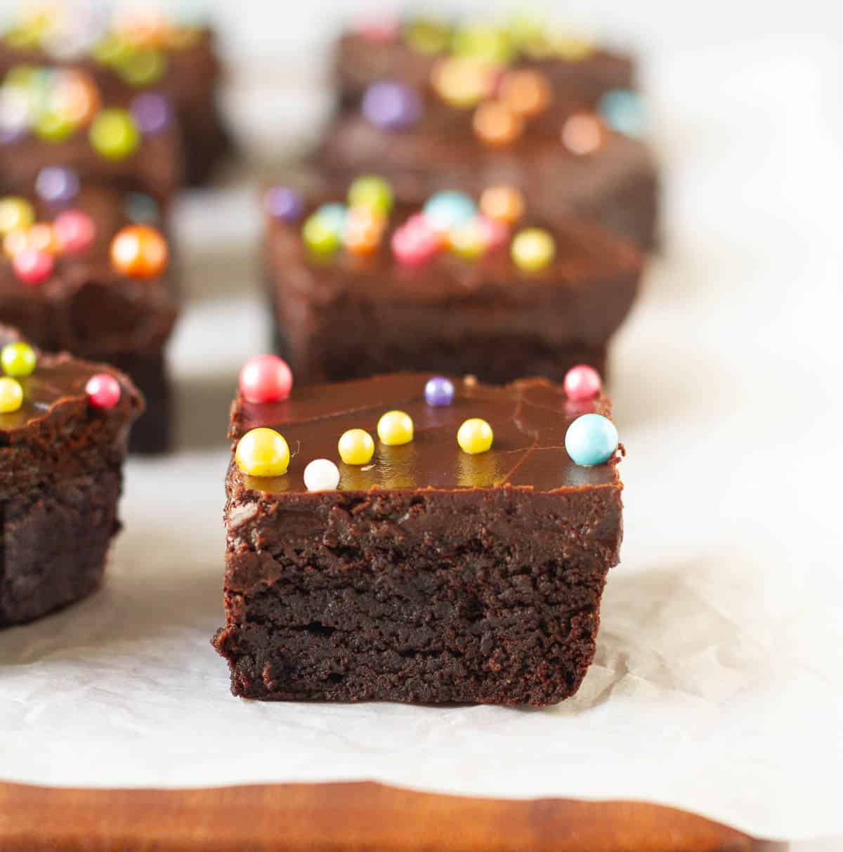 Brownie squares with chocolate frosting and rainbow sprinkles.