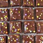 Brownie squares with chocolate frosting and sprinkles.