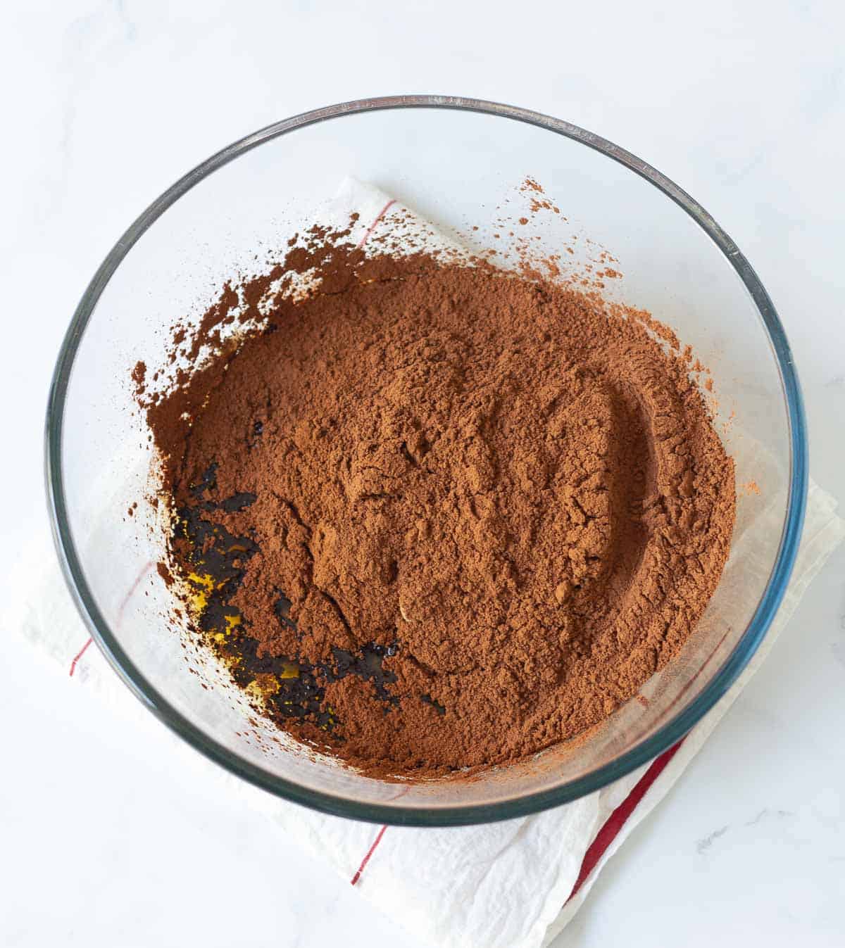 Melted butter, sugar, and cocoa powder in a mixing bowl.