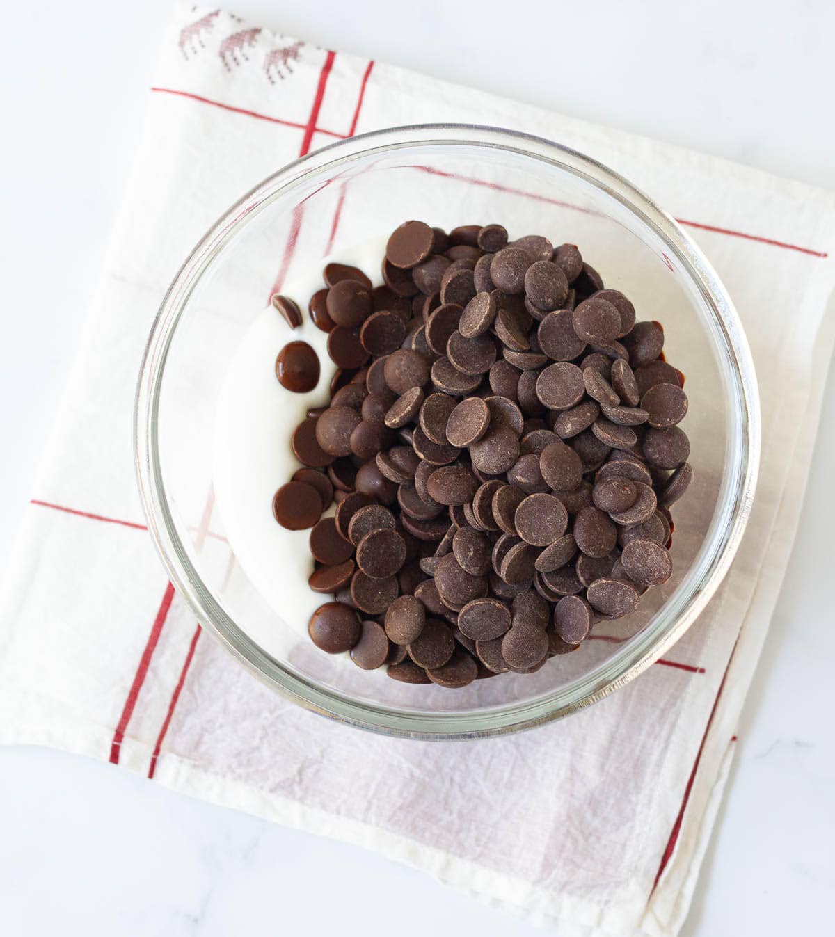 Cream and chocolate chips in a small mixing bowl.