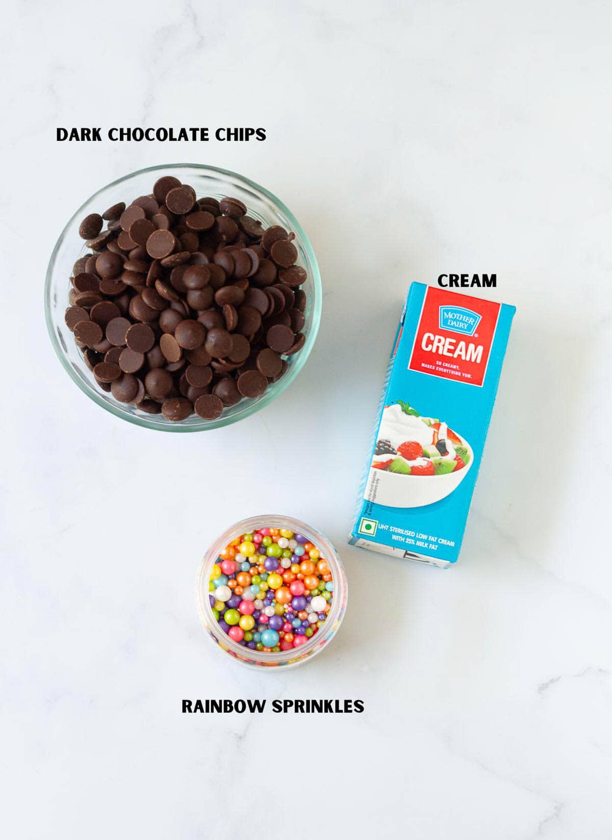 Labelled ingredients for making chocolate frosting and rainbow sprinkles.