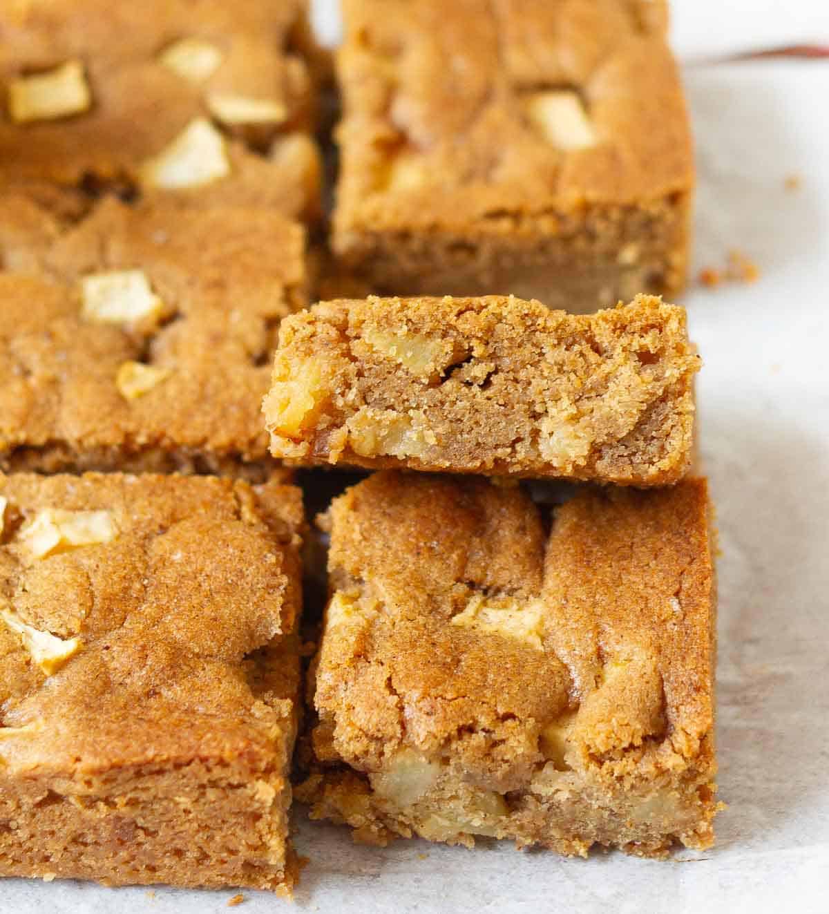 Apple blondie bars on parchment paper.