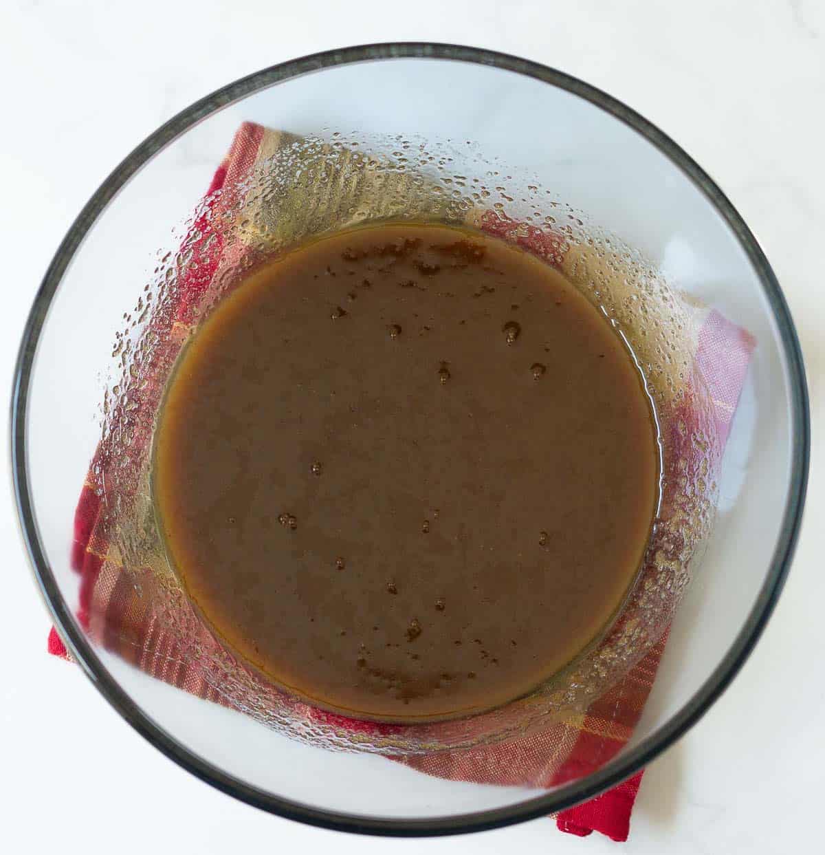 A mixture of butter and brown sugar in a mixing bowl.
