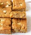 Apple blondie bars on parchment paper.