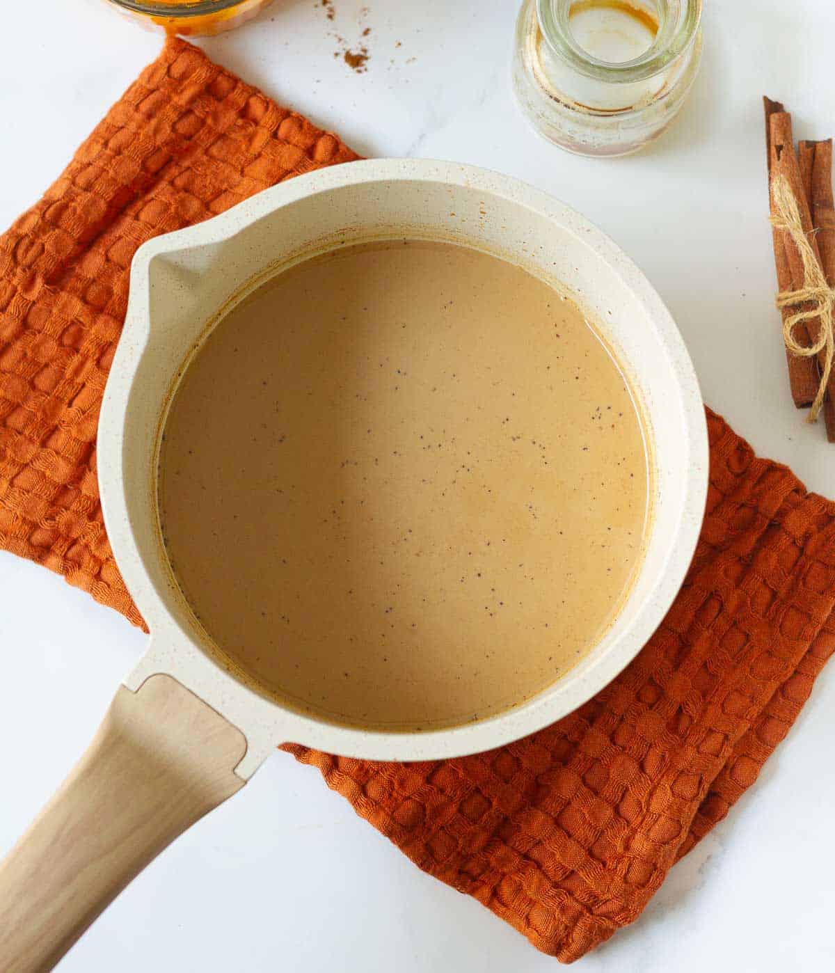 Milk, coffee, and pumpkin puree mixture in a small saucepan.