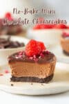Half a chocolate cheesecake with raspberries on top on a plate.