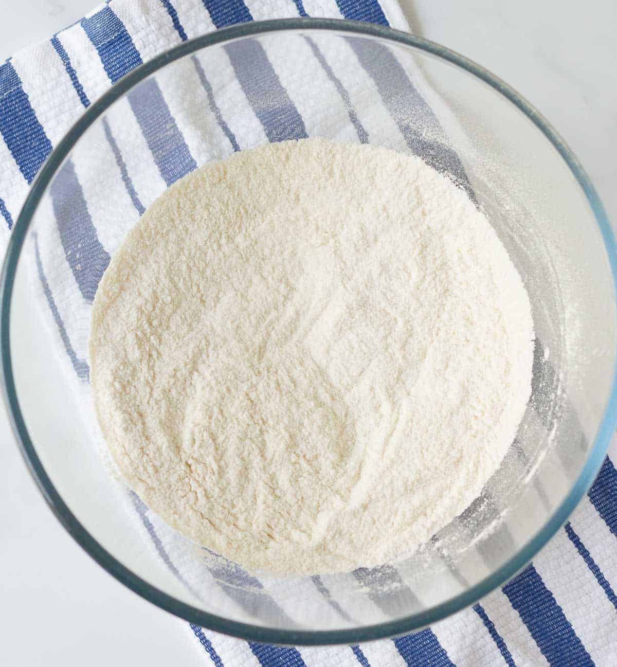 Dry ingredients for making pancakes in a mixing bowl.