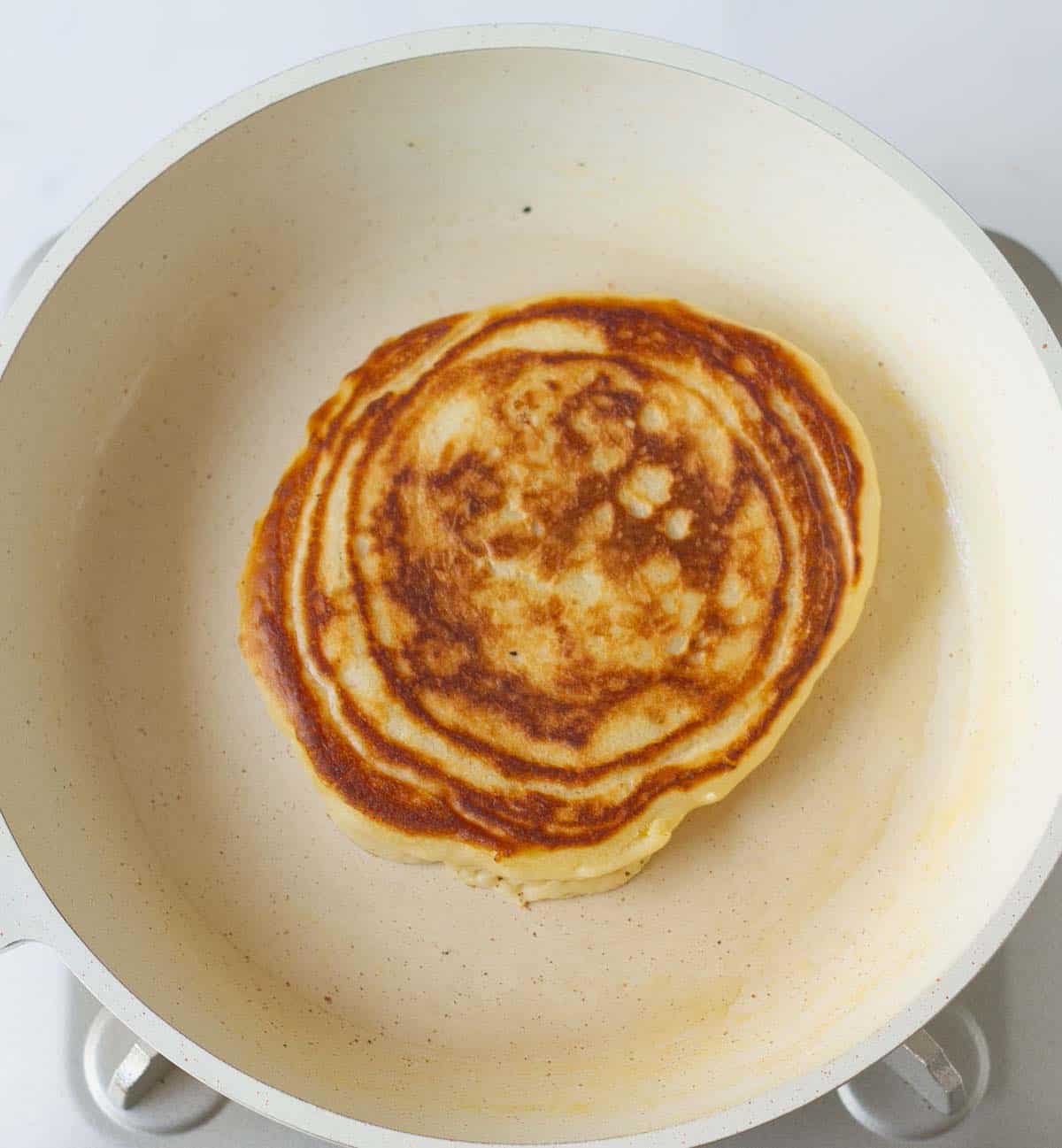 Golden cooked pancake in a skillet.