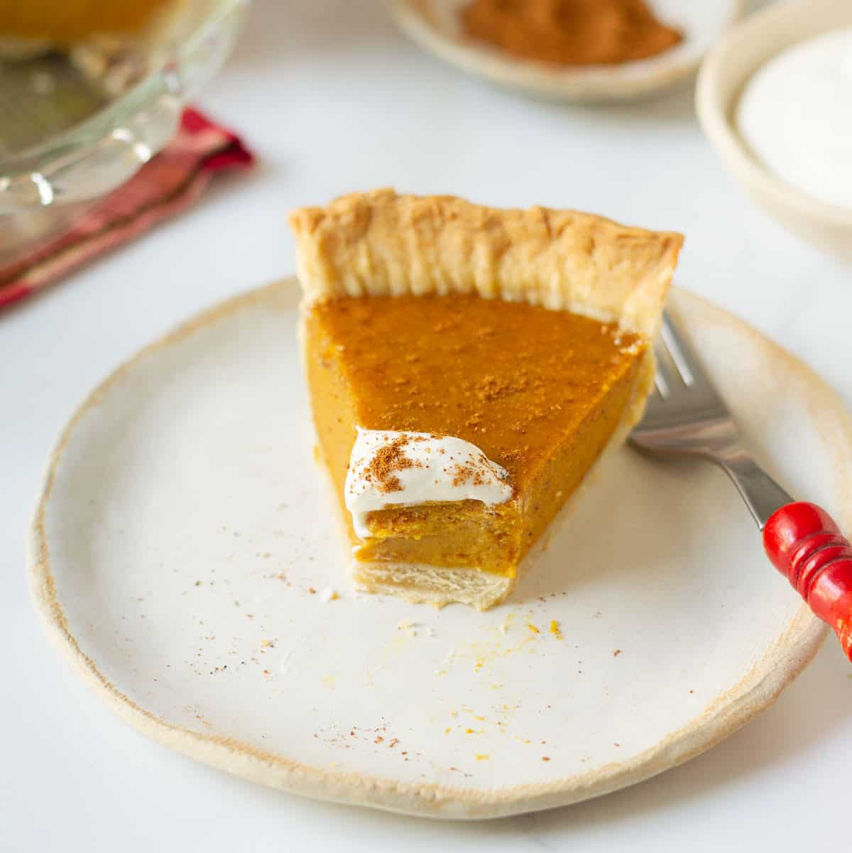 A slice of pie on a plate with a bite taken.