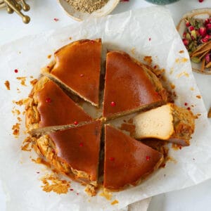 Slices of chai cheesecake on parchment paper with one slice sideways.