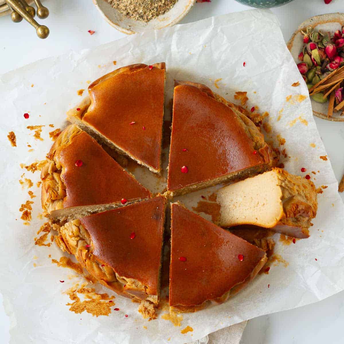 Slices of chai cheesecake on parchment paper with one slice sideways.